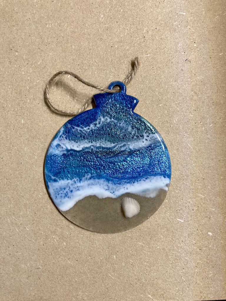 Wooden Christmas tree round ornament with resin coastal design.