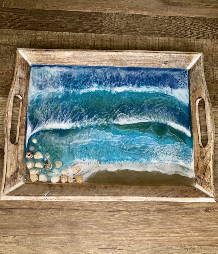 Wood decorative tray with seashells, sand, water and waves created using resin.