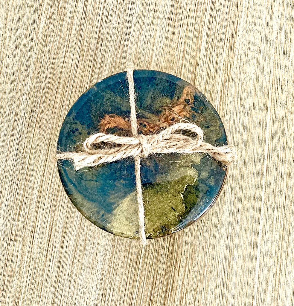 Round wood coaster set with resin coating inspired by the dancing embers in a campfire.