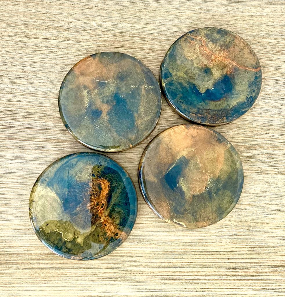 Round wood coaster set with resin coating inspired by the dancing embers in a campfire.