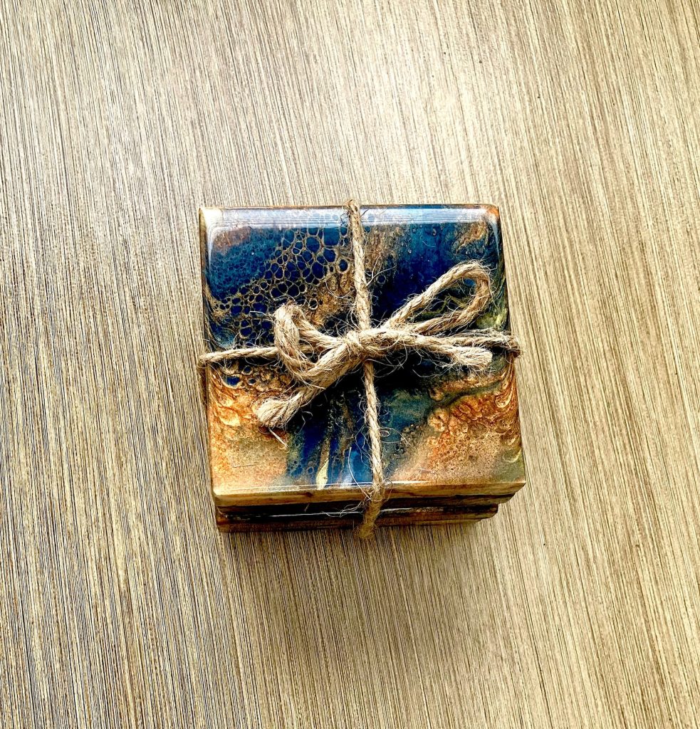 Square wood coaster set with resin coating inspired by the dancing embers in a campfire.