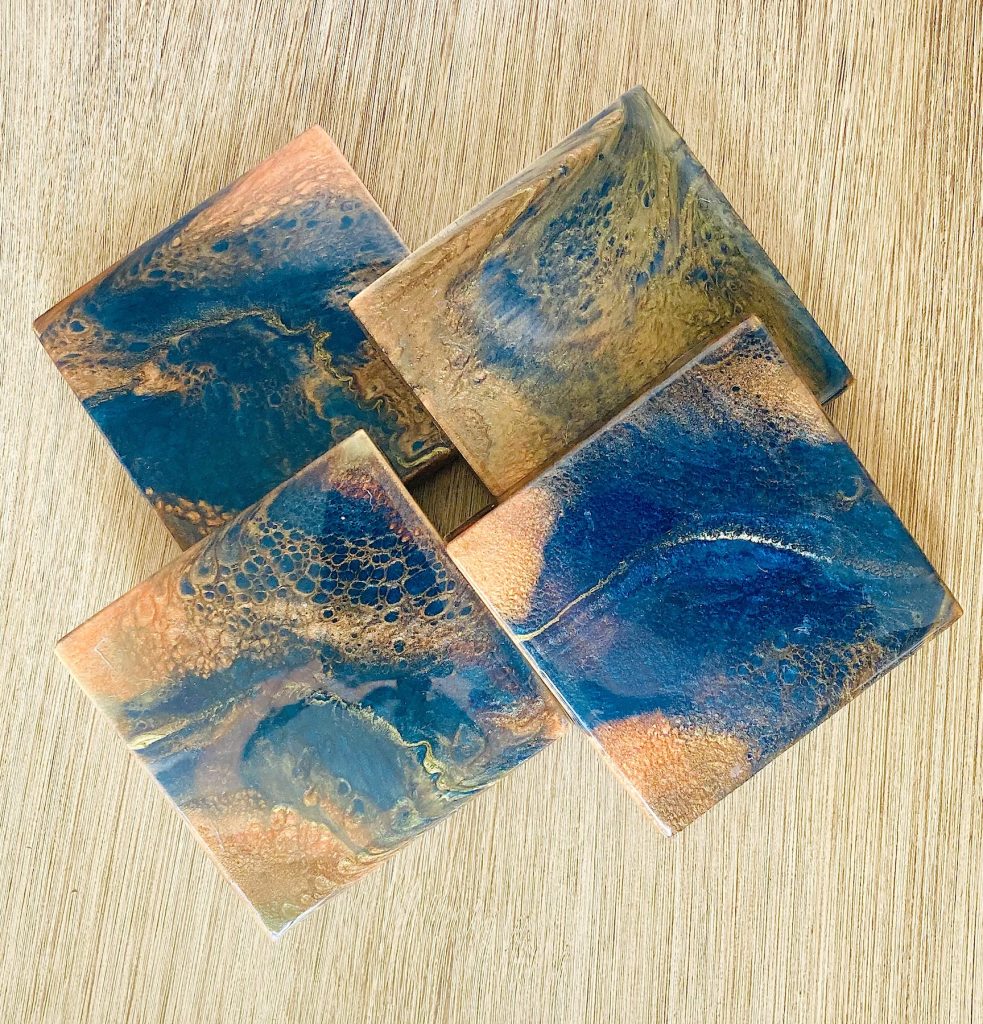 Square wood coaster set with resin coating inspired by the dancing embers in a campfire.