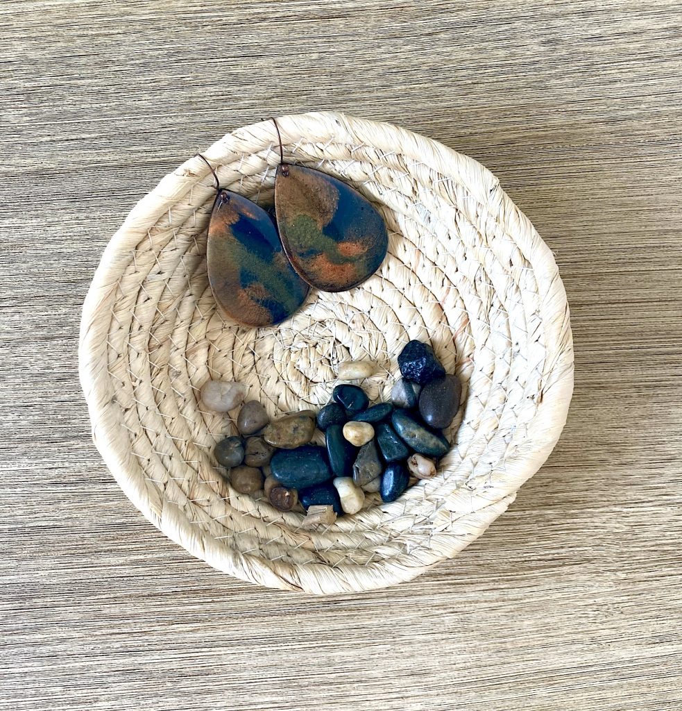 Wood teardrop shaped earrings coated in campfire nights inspired resin.