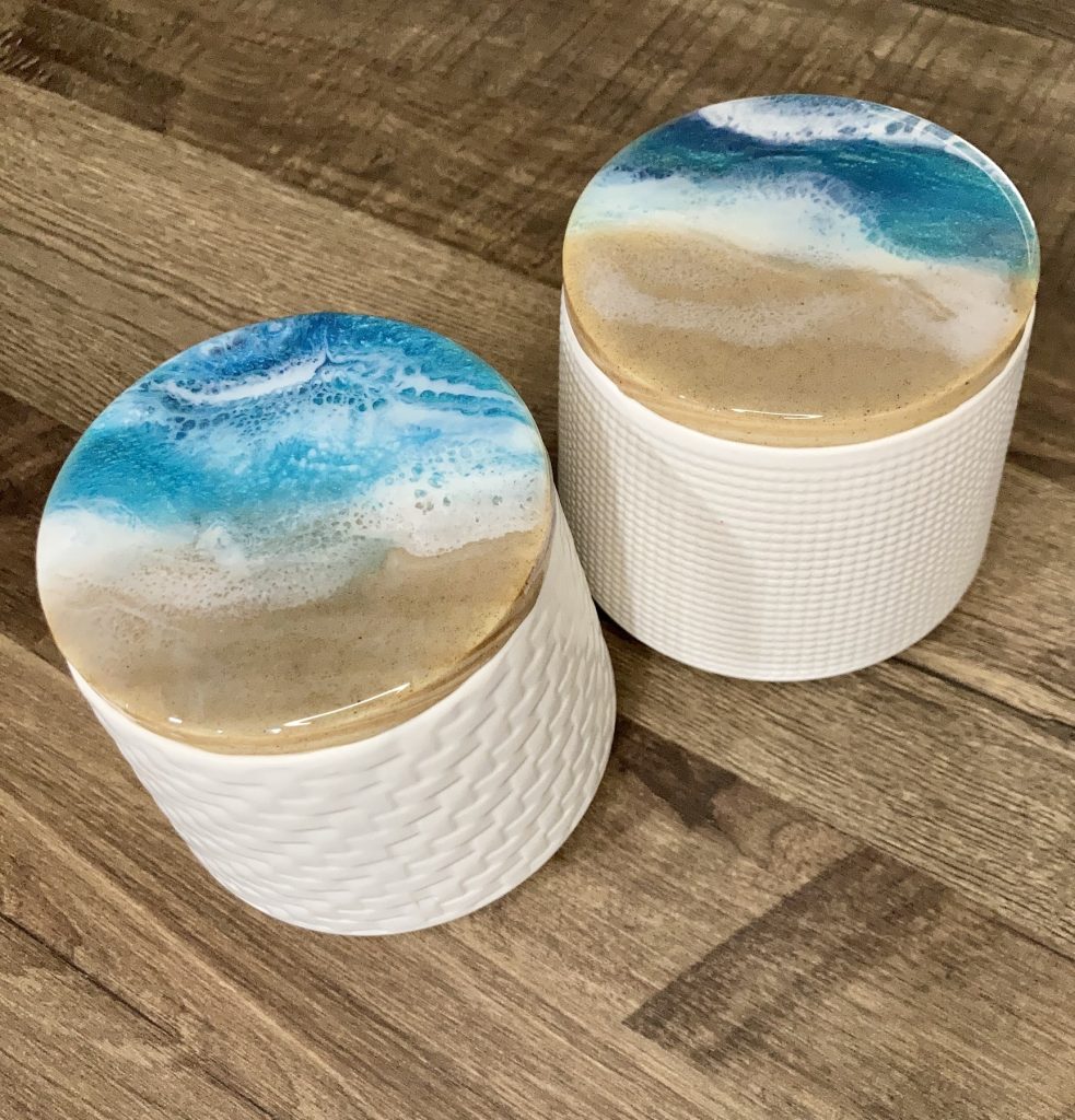 Ceramic canister set with wood lids with resin in a coastal design.