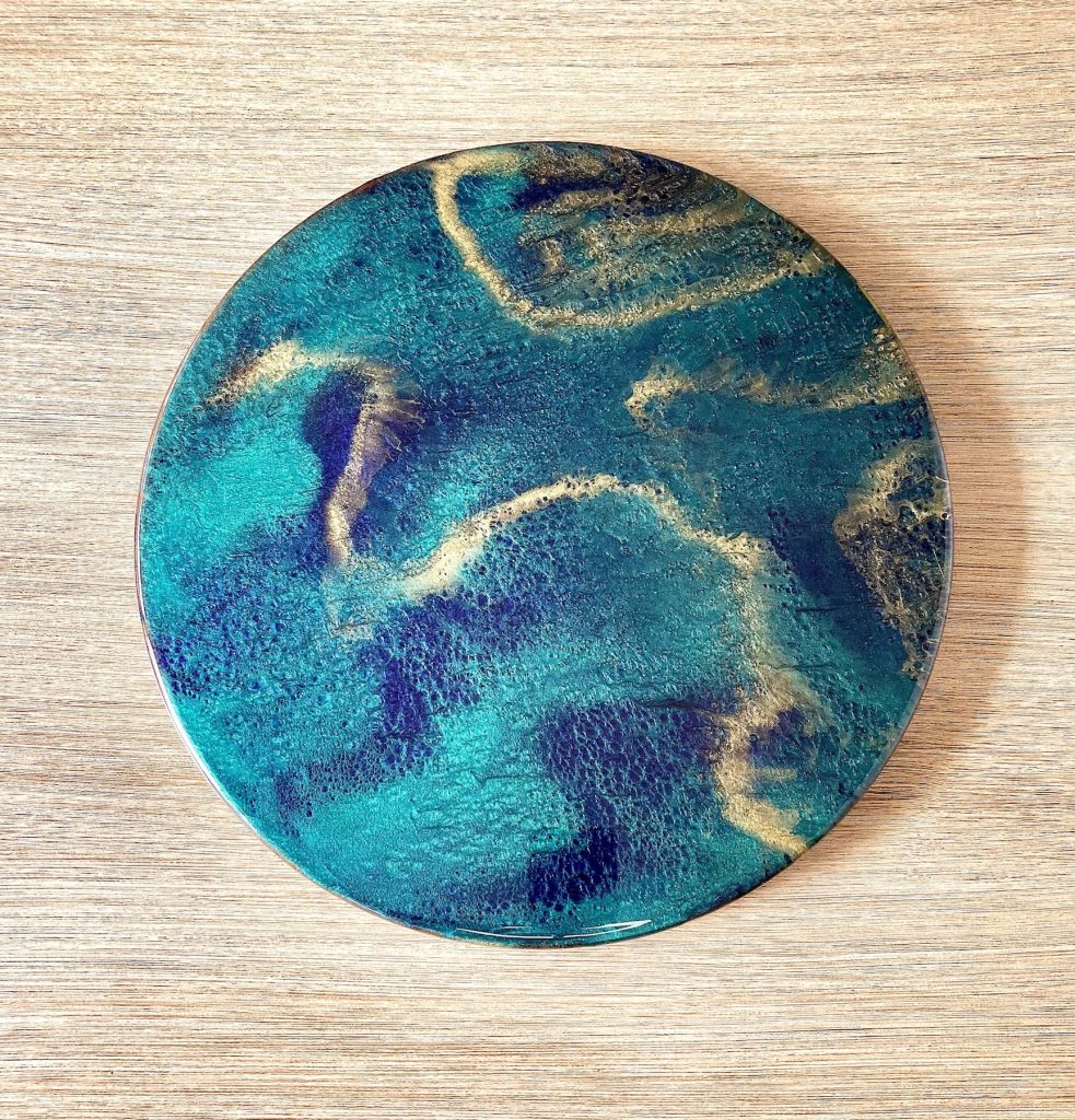 Large round lazy susan with midnight lake resin decoration.